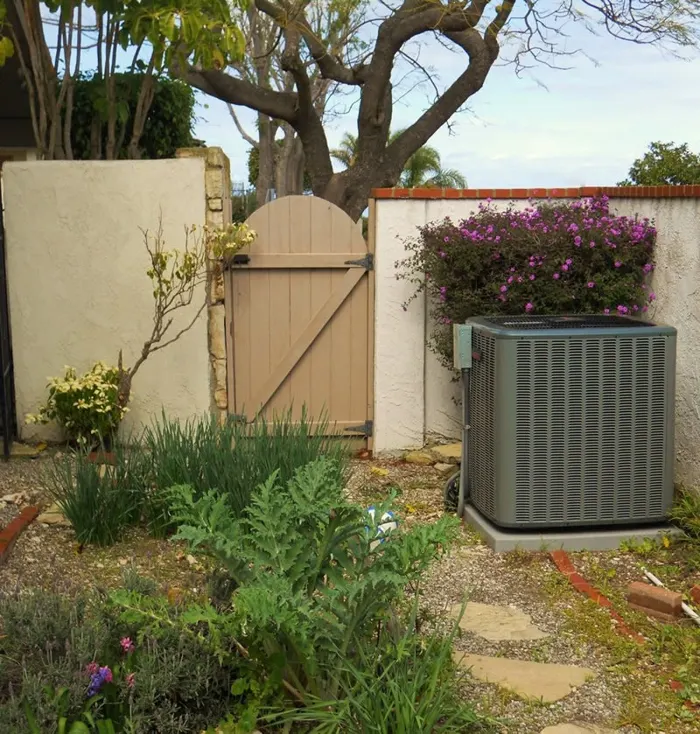 New AC condenser installed in a garden side yard